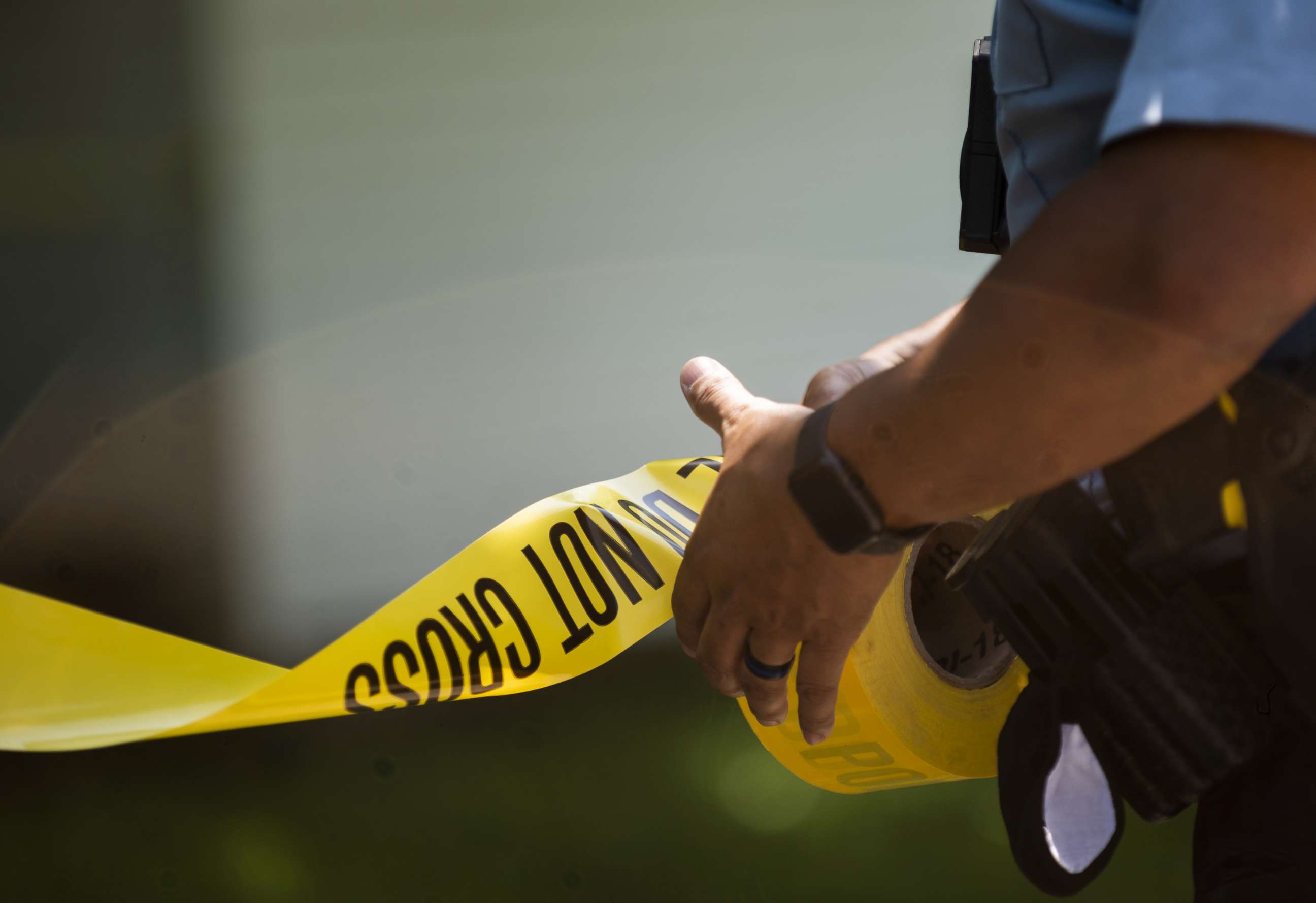 PHOTO: A Minneapolis Police officers unrolls caution tape at a crime scene on June 16, 2020 in Minneapolis, Minnesota. 