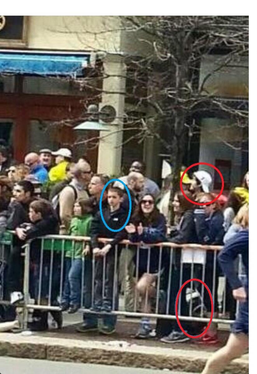 PHOTO: A screen grab shows what appears to be Martin Richard, circled left, the 8 year old victim of the Boston Marathon bombings and one of the suspects, circled right, minutes before the bomb went off, April 15, 2013.