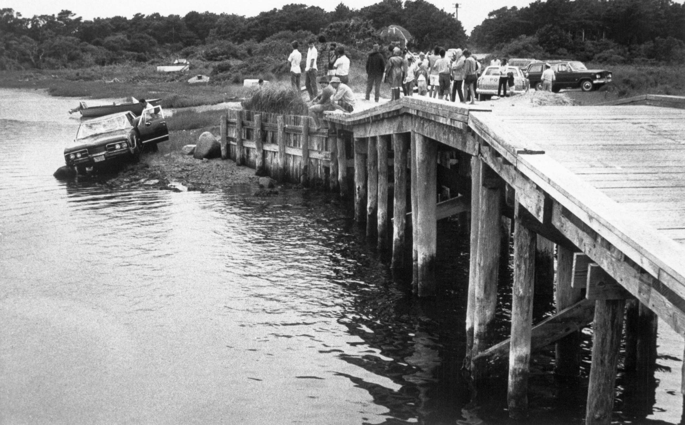 PHOTO: Spectators look at the car driven by Massachusetts Senator Edward Kennedy which plunged off a bridge on Martha's Vineyard on July 19, 1969. Kennedy escaped from the crash but Mary Jo Kopechne, 29, of Washington, D.C., was killed.