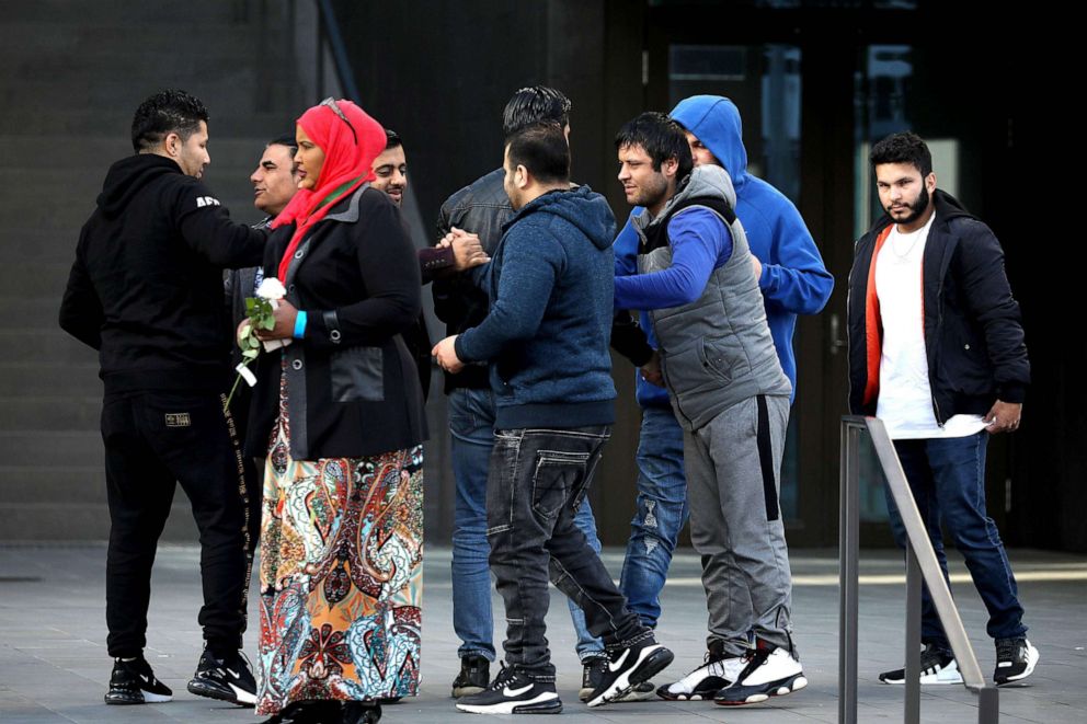 PHOTO: Survivors and family members of the 2019 twin mosque shootings greet each other outside the High Court building on the last day of the sentencing hearing for Brenton Tarrant, on Aug. 27, 2020.