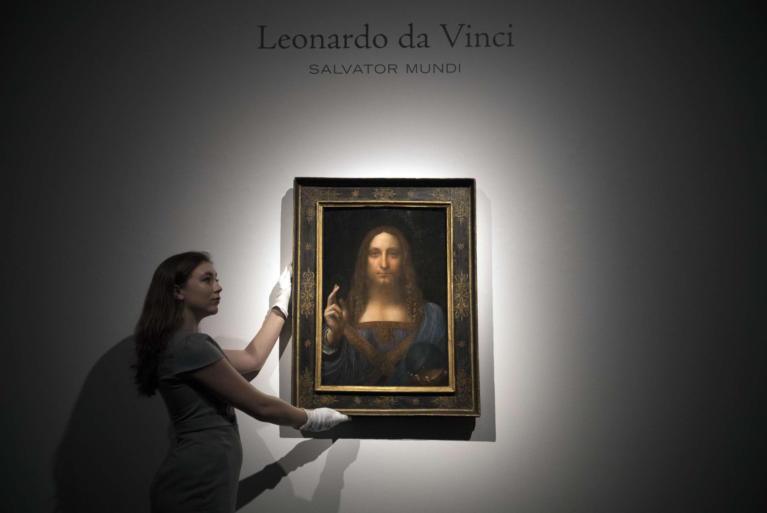 PHOTO: A staff member poses with a painting by Leonardo da Vinci entitled 'Salvator Mundi' in London on OCt. 24, 2017, before it is auctioned in New York. The painting is the last privately owned Da Vinci and is expected to fetch around $100,000,000. 