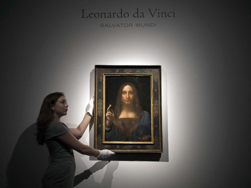 PHOTO: A staff member poses with a painting by Leonardo da Vinci entitled Salvator Mundi in London on OCt. 24, 2017, before it is auctioned in New York. The painting is the last privately owned Da Vinci and is expected to fetch around $100,000,000.