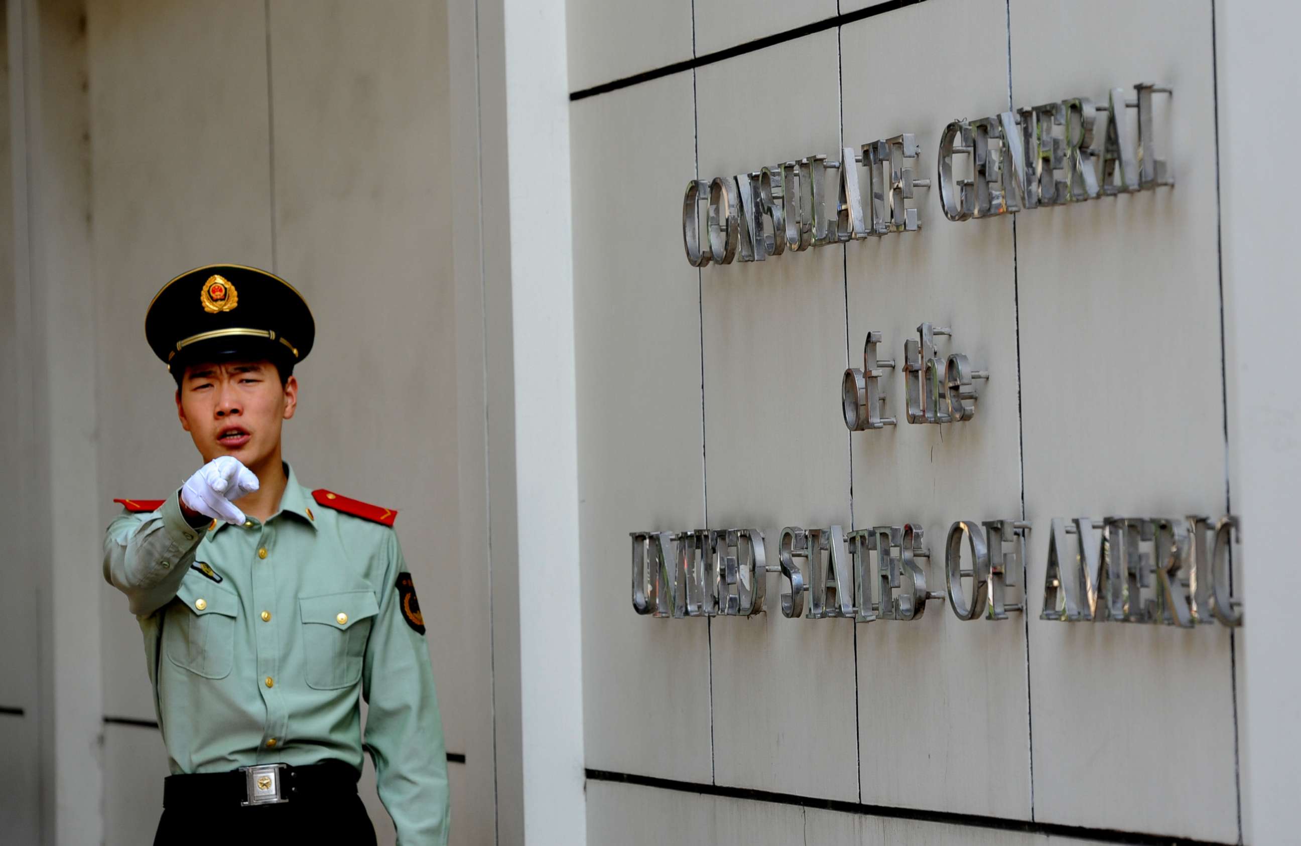 PHOTO: (FILES) This file photo taken on September 18, 2012 shows a Chinese paramilitary policeman gesturing to photographers at the entrance to the US consulate in Chengdu, southwest China's Sichuan province.