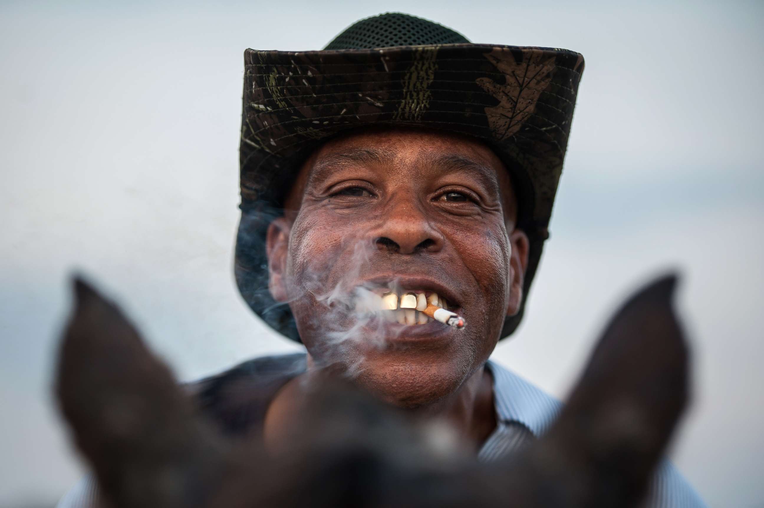 PHOTO: A cowboy named James shows off his golden grill while smoking a cigarette in Bolivar County, Miss.