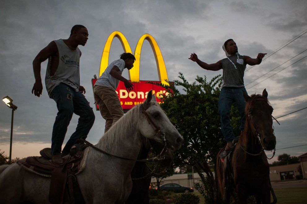PHOTO: A group of young cowboys dance atop their horses in the McDonald's parking lot in Cleveland, Miss.