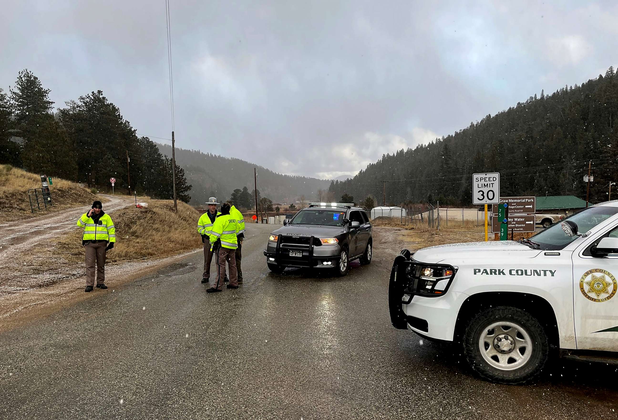 PHOTO: Sheriff deputies block a road in the town of Bailey, Colo., where authorities found an abandoned car that belonged to the suspect in a shooting of two administrators at a Denver high school, March 22, 2023.