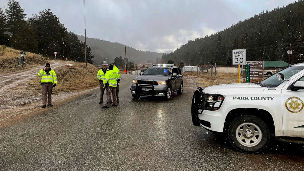 PHOTO: Sheriff deputies block a road in the town of Bailey, Colo., where authorities found an abandoned car that belonged to the suspect in a shooting of two administrators at a Denver high school, March 22, 2023.