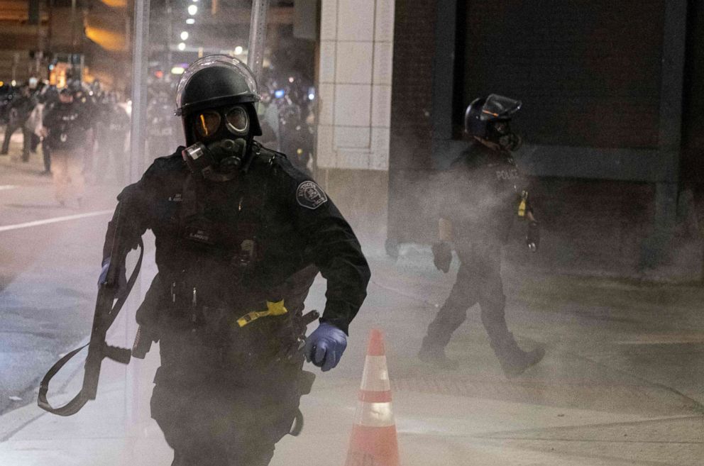PHOTO: A Detroit Police officer uses tear-gas during a protest in the city of Detroit, Michigan, on May 29, 2020, over the death of George Floyd, a black man who died after a white policeman kneeled on his neck for several minutes. 