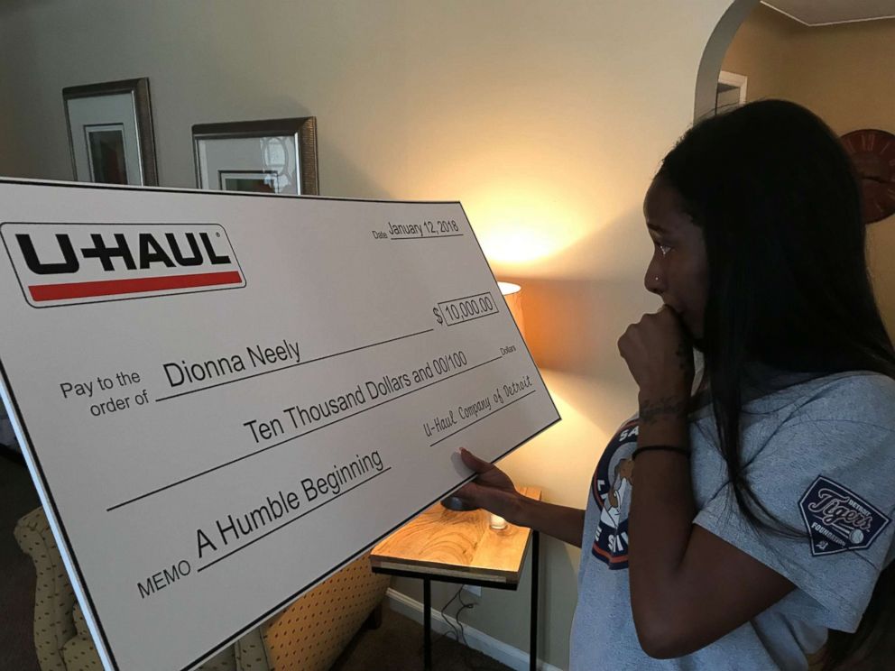 PHOTO: Dionna Neely was presented with a check to help her finish nursing school by the U-Haul Company of Detroit Jan. 12. She said she and son Daerye were incredibly grateful to everyone who'd helped their family.
