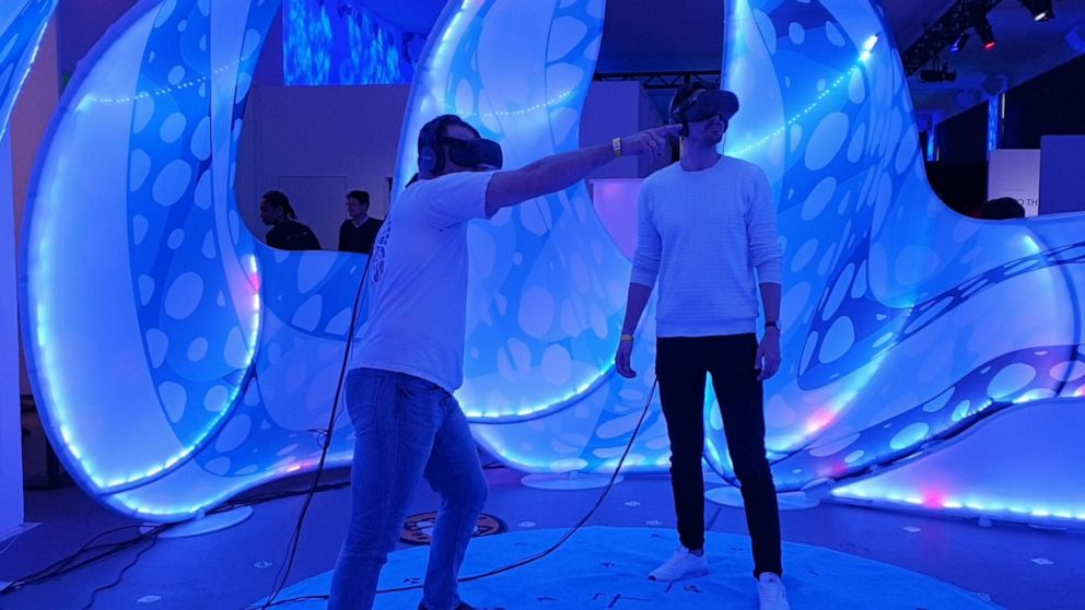 PHOTO: Two users in VR experiencing Drop In The Ocean