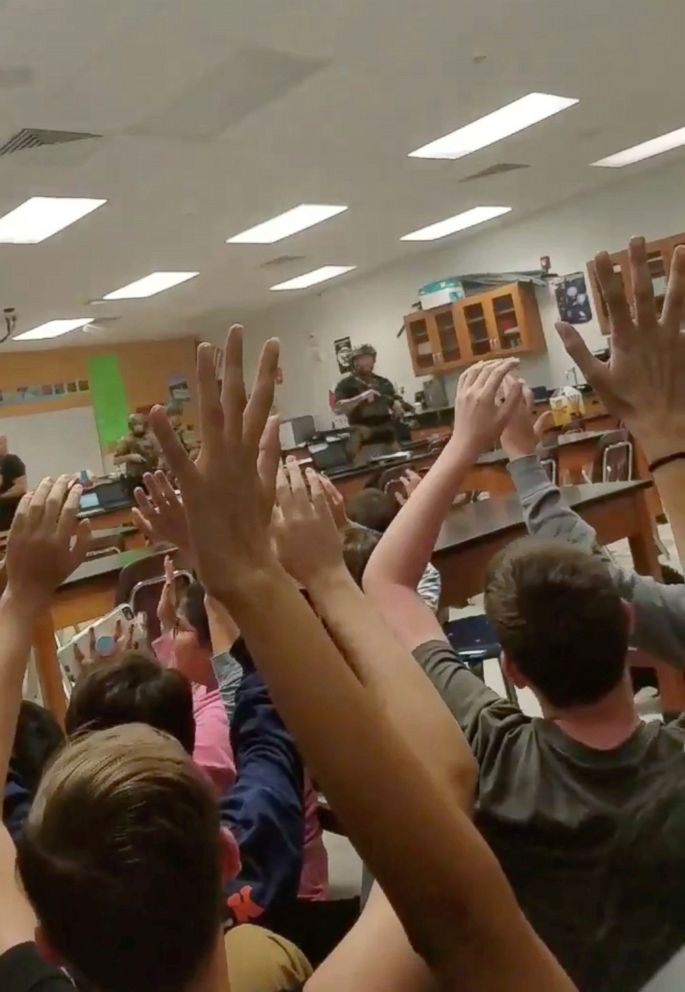 PHOTO: Students put their hands up in the air as armed police enter their classroom, following a shooting at the Marjory Stoneman Douglas High School in Parkland, Fla, in an image taken from a Feb. 14, 2018 social media video.