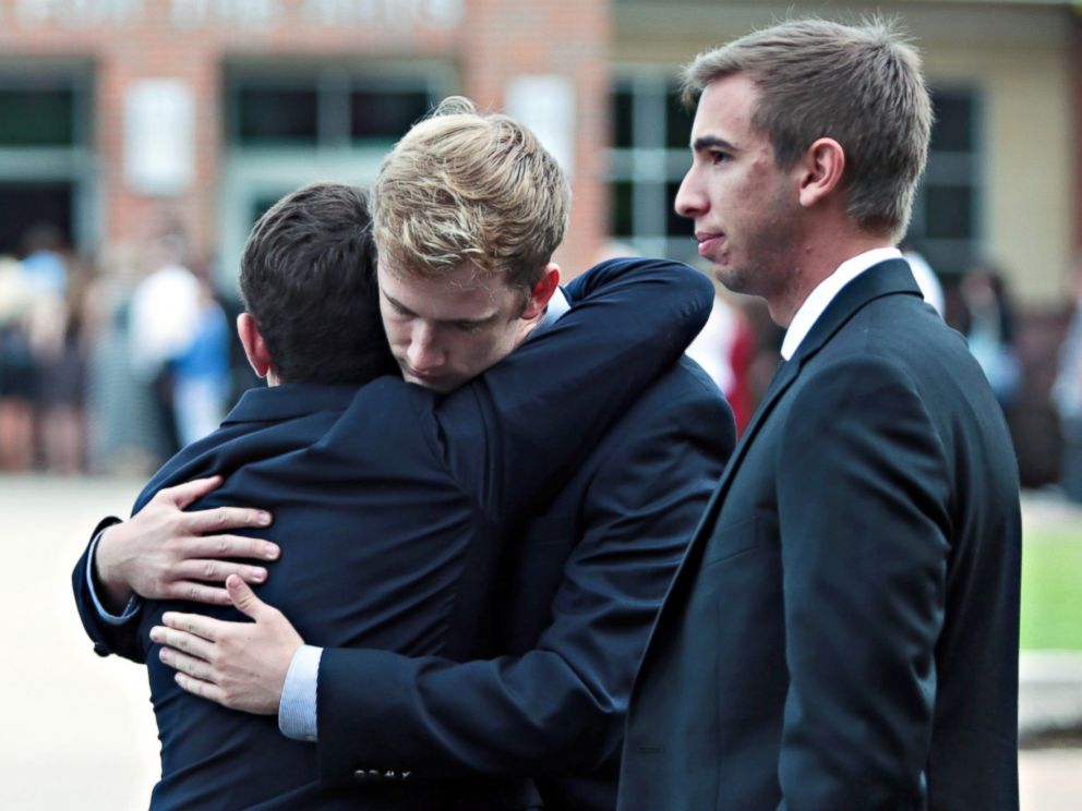 PHOTO: Mourners hug at the funeral of Otto Warmbier outside Wyoming High School in Wyoming, Ohio, June 22, 2017. Warmbier died on June 19, 2017 a few days after his release from North Korea in a coma. 