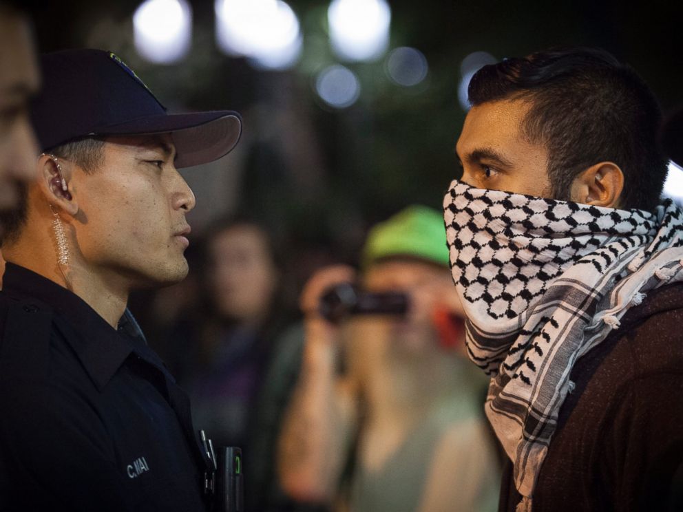 PHOTO: A demonstrator face off with police during a march through the streets in protest against President-elect Donald Trump in Oakland, California, Nov. 10, 2016.