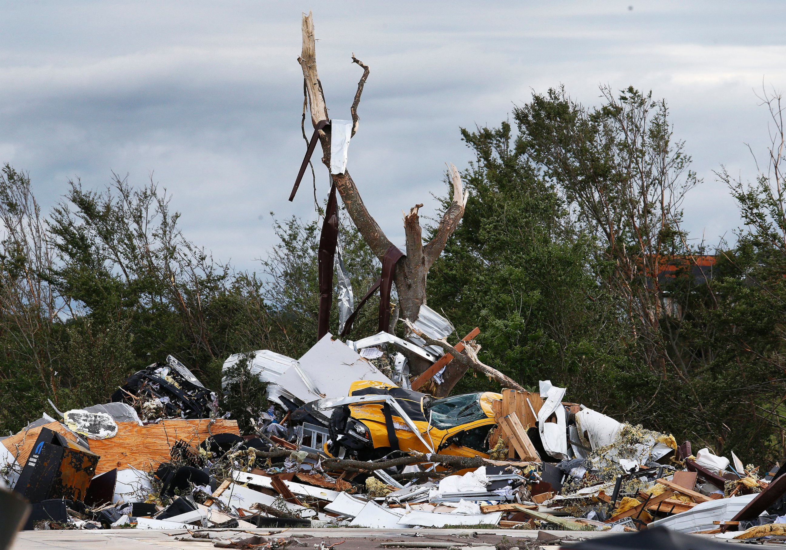 PHOTO: Cars and damaged material is seen piled up at a local car dealership that was destroyed when a large tornado hit the area near Canton, Texas, April 30, 2017.