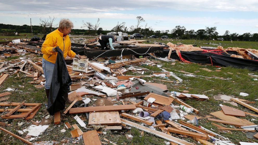 PHOTO: Two women retrieve items for their neighbor from the remains of their trailer home that was destroyed when a large tornado hit the area near Canton, Texas, April 30, 2017. 