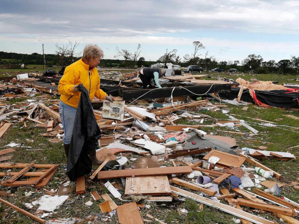 PHOTO: Two women retrieve items for their neighbor from the remains of their trailer home that was destroyed when a large tornado hit the area near Canton, Texas, April 30, 2017.
