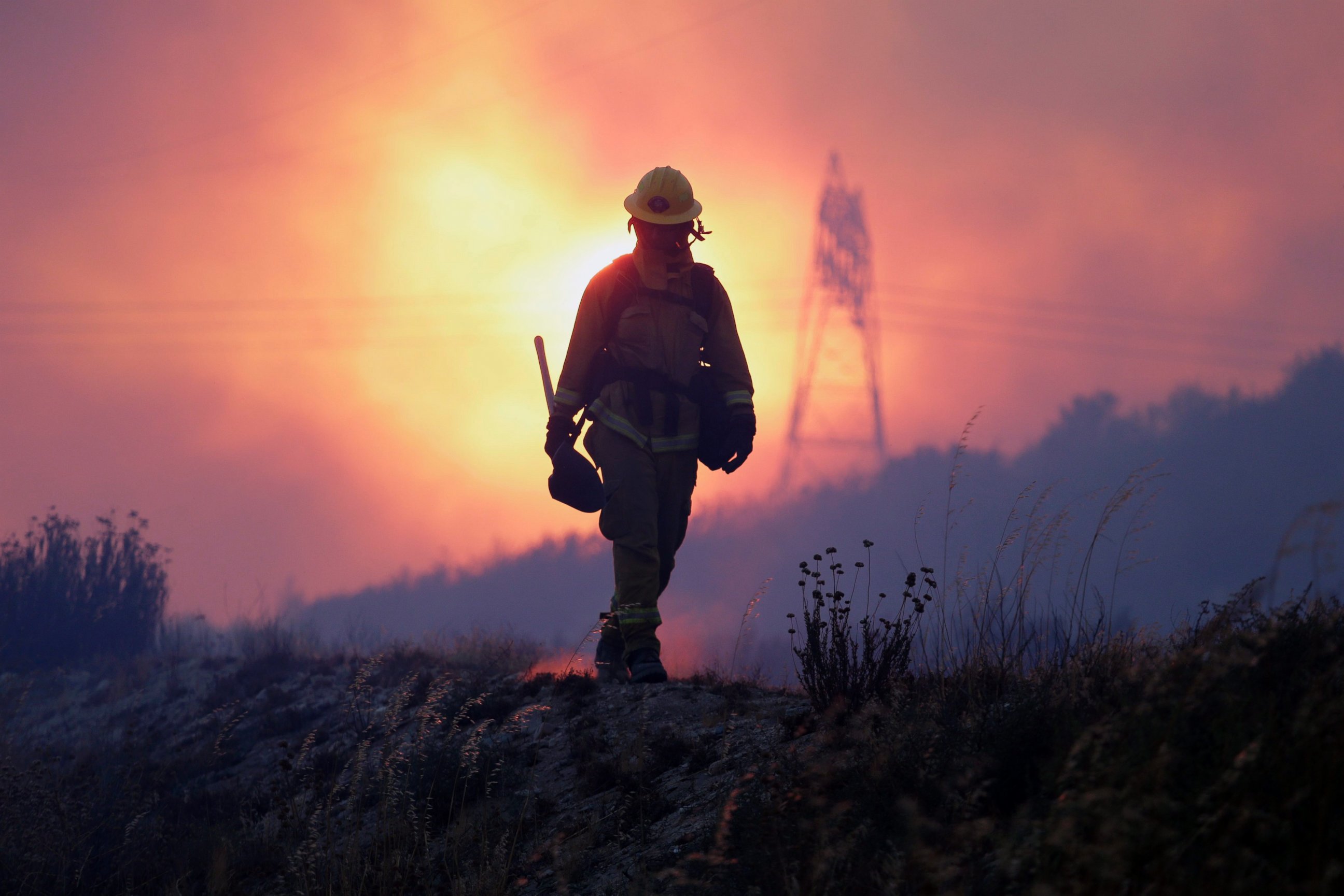 PHOTO: A firefighter keeps an eye on the Blue Cut fire line, north of Los Angeles, California, Aug. 16, 2016.