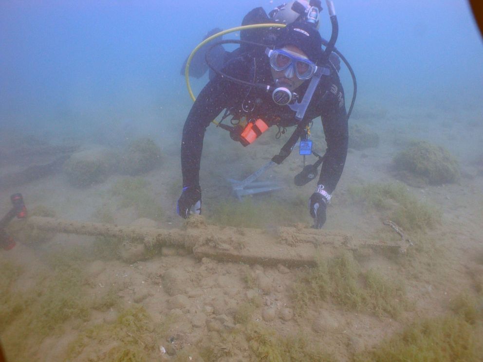 PHOTO: Erik Denson in 2015 with a gun found from a Tuskegee Airman's plane wreck in Lake Huron.