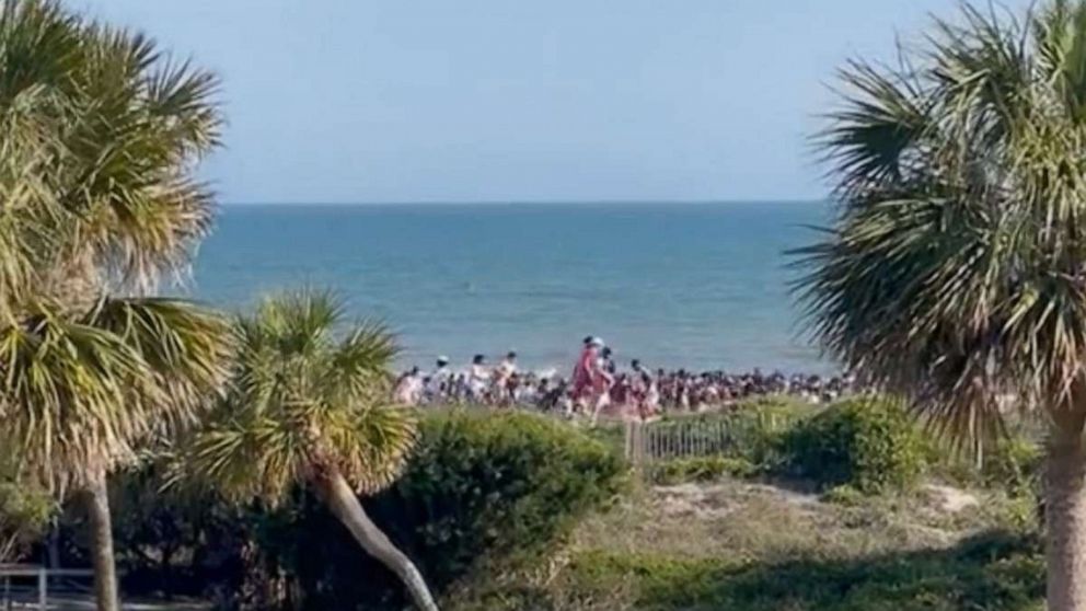 PHOTO: Beachgoers run from the site of a shooting in Isle of Palms, South Carolina.