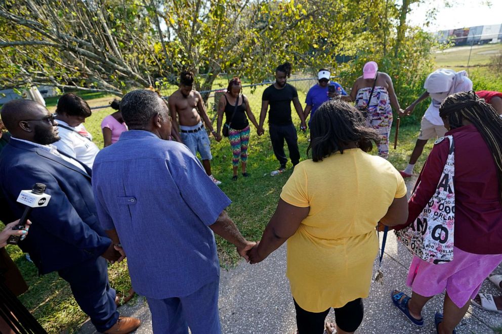 PHOTO: Residents gather for a prayer near the scene of a mass shooting Saturday, Aug. 26, 2023, in Jacksonville, Fla. (AP Photo/John Raoux)
