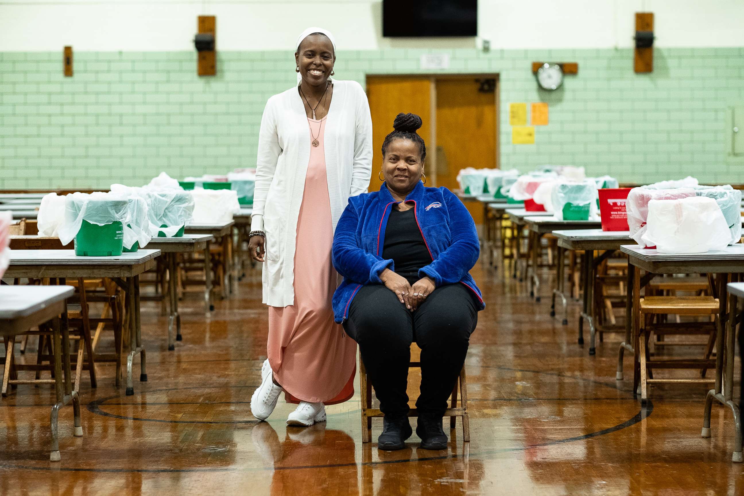 PHOTO: Tops co-workers Toy Benefield (seated) and Fragrance Harris Stanfield pose for this photo on Oct. 13, 2022, following a BINGO game at Blessed Trinity Catholic Church in Buffalo.
