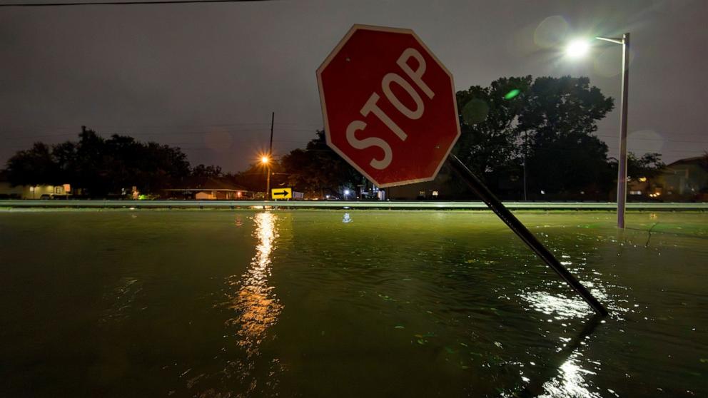 PHOTO: A bent stop sign is seen at Neyrey Dr. and W. Napoleon Ave where water from the W. Napoleon drainage canal overtopped after a deluge of rain from Hurricane Francine in Metairie, La., in Jefferson Parish, Sept. 11, 2024.