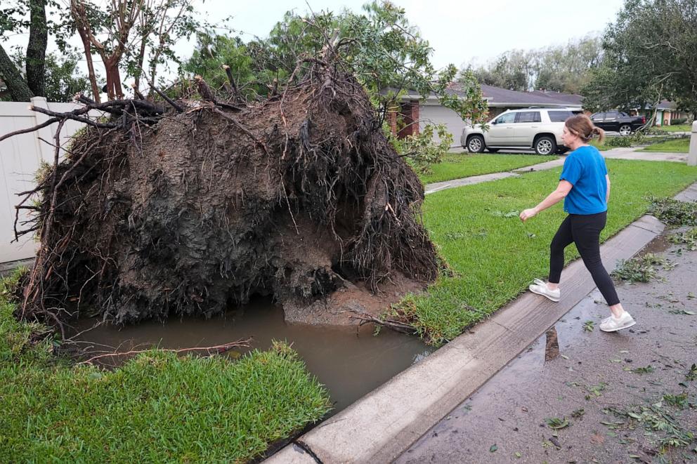 PHOTO: Pamela Miller walks around a tree that fell on her house in the aftermath of Hurricane Francine, in Morgan City, La.,  Sept. 12, 2024. 