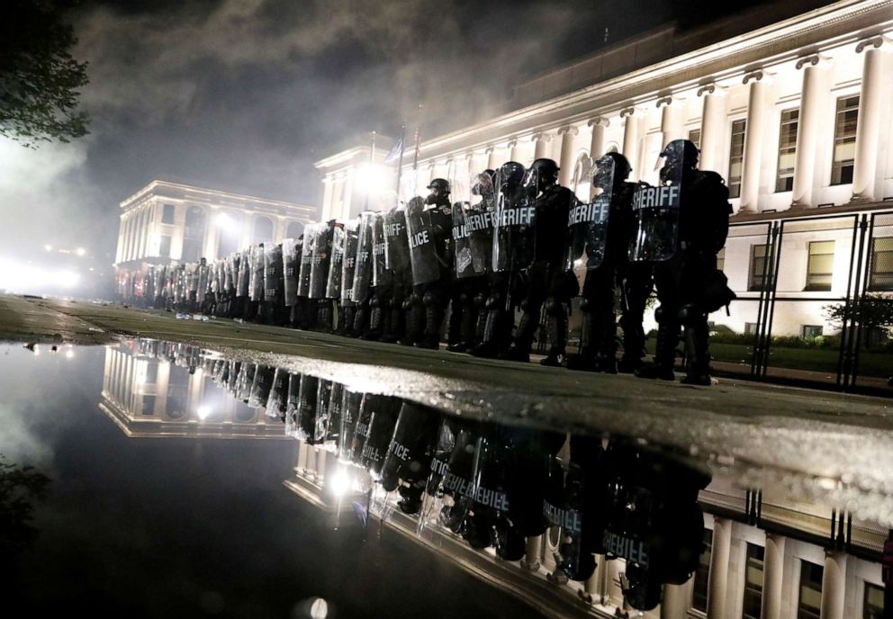 PHOTO: Law enforcement officers guard during a protest following the police shooting of Jacob Blake, a Black man, in Kenosha, Wisconsin, U.S. August 25, 2020. 