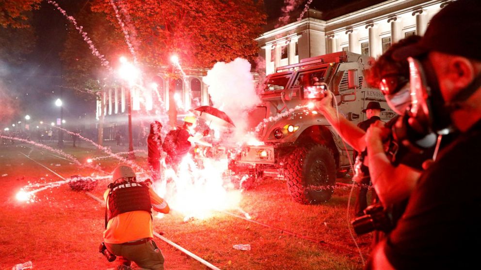 PHOTO: Flares go off in front of a Kenosha Country Sheriff Vehicle as demonstrators take part in a protest following the police shooting of Jacob Blake, a Black man, in Kenosha, Wisconsin, U.S. August 25, 2020. REUTERS/Brendan McDermid    
