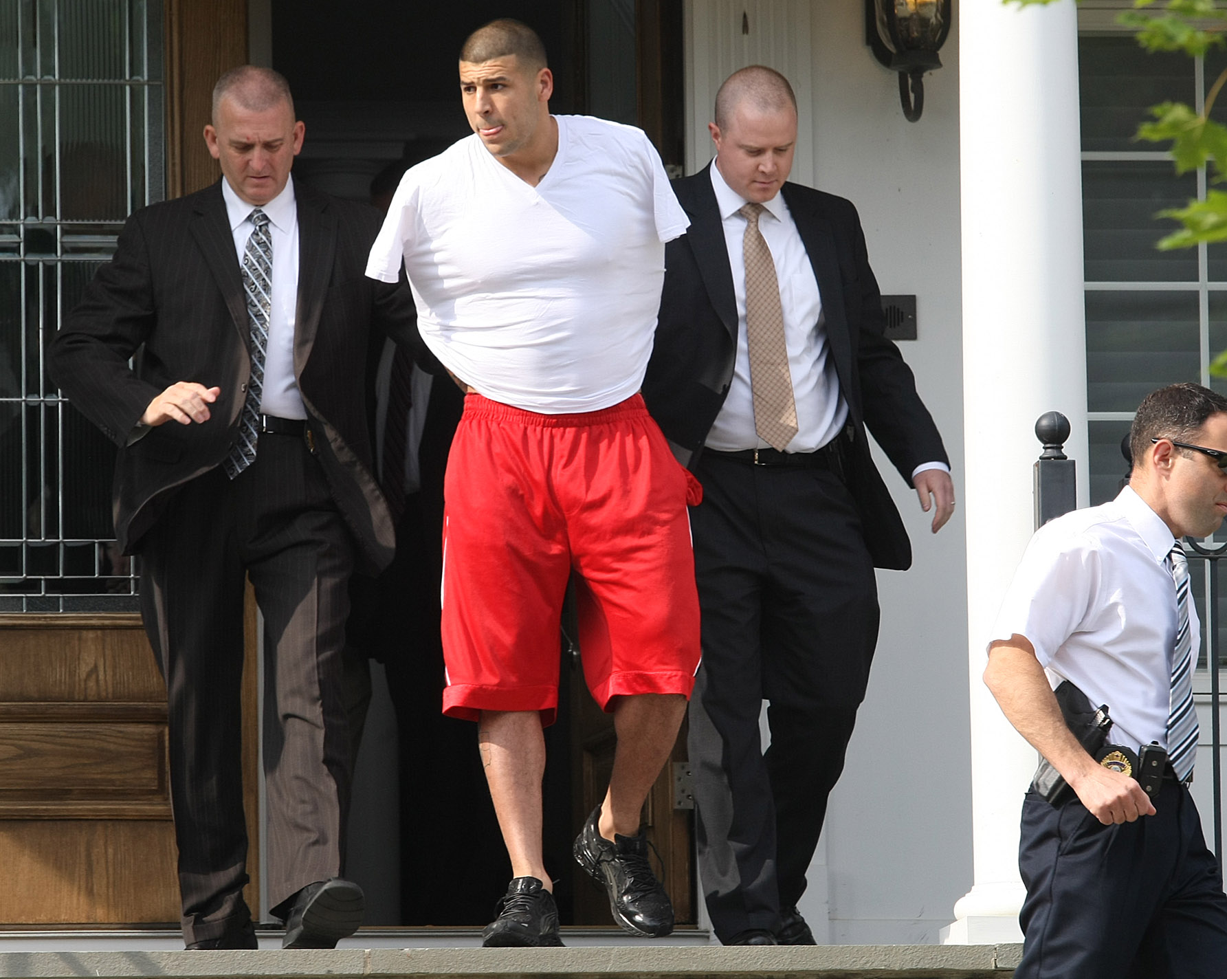 PHOTO: New England Patriots tight end Aaron Hernandez was arrested and led out of his home in handcuffs, on June 26, 2013, North Attleborough, Mass. 