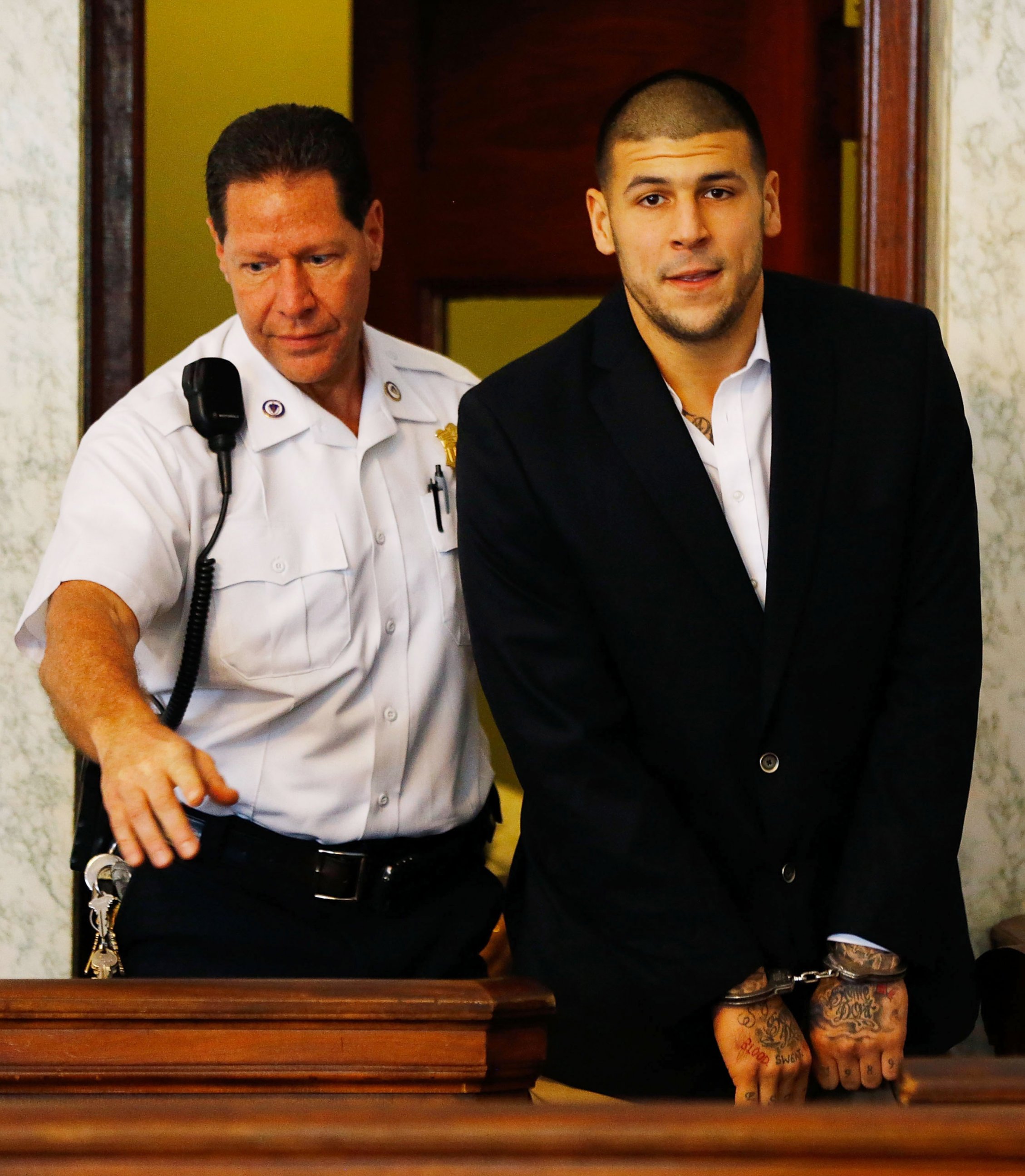 PHOTO: Aaron Hernandez is escorted into the courtroom of the Attleboro District Court for his hearing, on Aug. 22, 2013, in North Attleboro, Mass. 