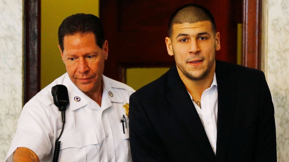 PHOTO: Aaron Hernandez is escorted into the courtroom of the Attleboro District Court for his hearing, on Aug. 22, 2013, in North Attleboro, Mass. 