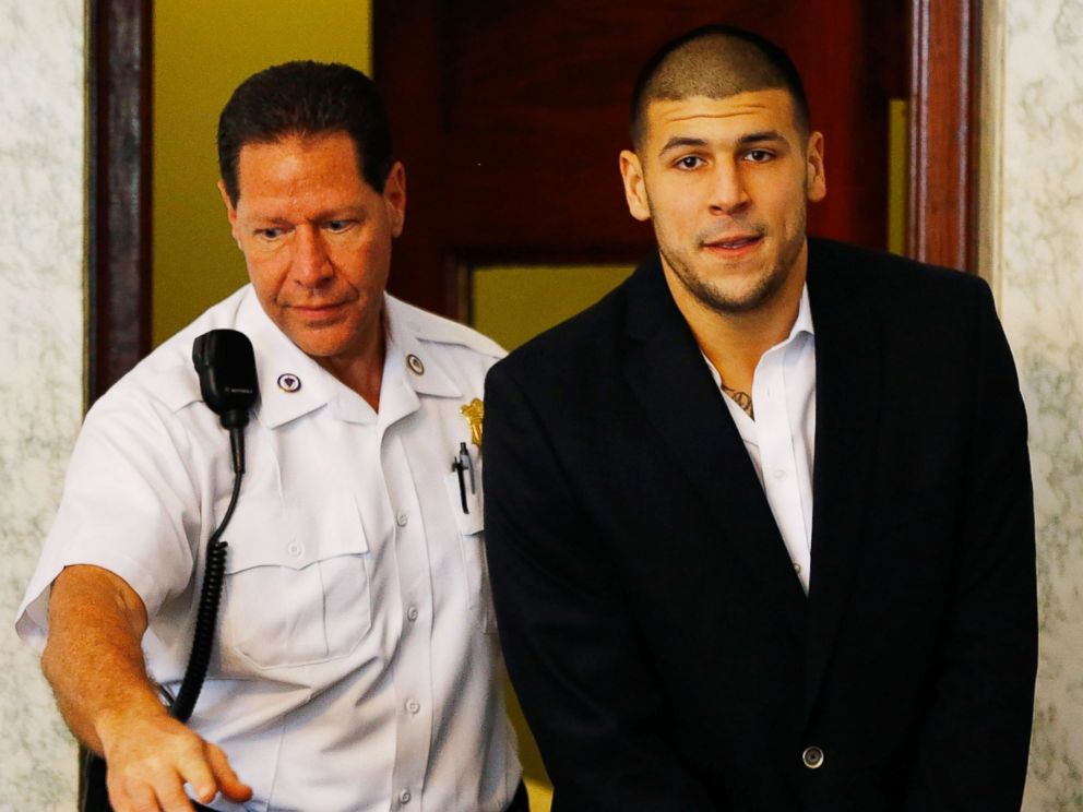 PHOTO: Aaron Hernandez is escorted into the courtroom of the Attleboro District Court for his hearing, on Aug. 22, 2013, in North Attleboro, Mass.
