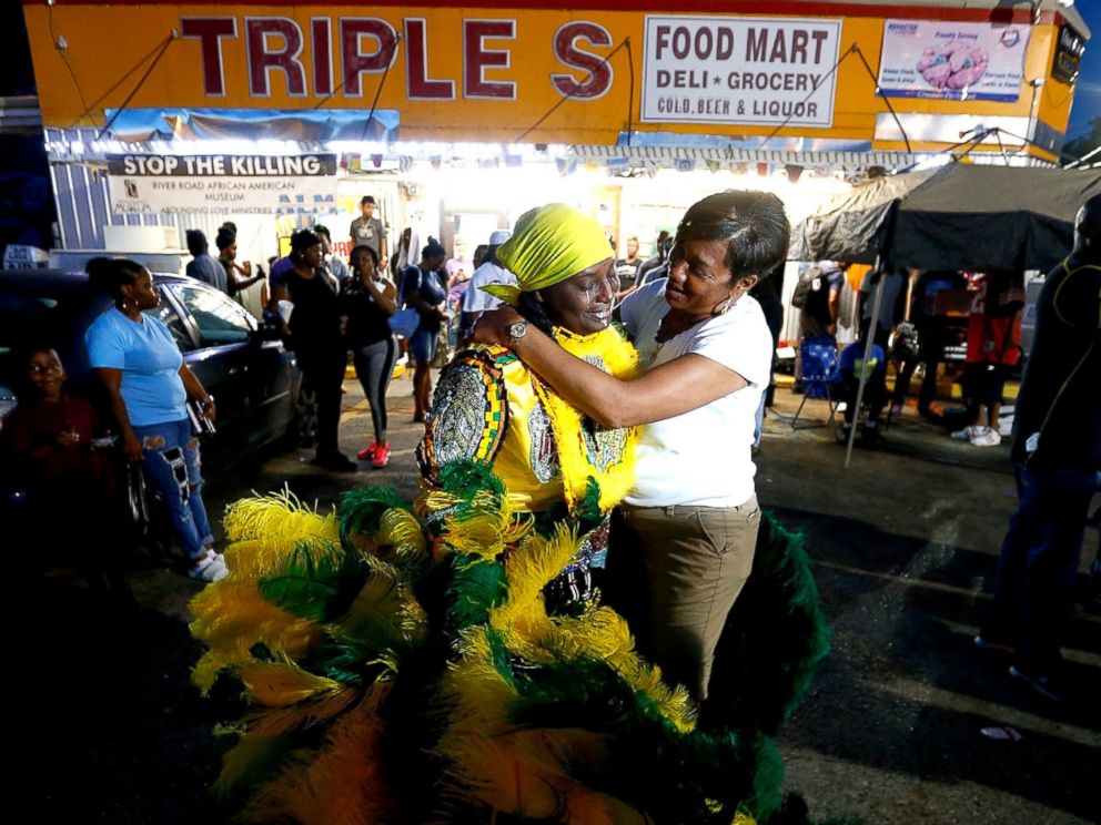 PHOTO: Members of the community stand in front of the Triple S Food Mart, on May 2, 2017, in Baton Rouge, Louisiana.