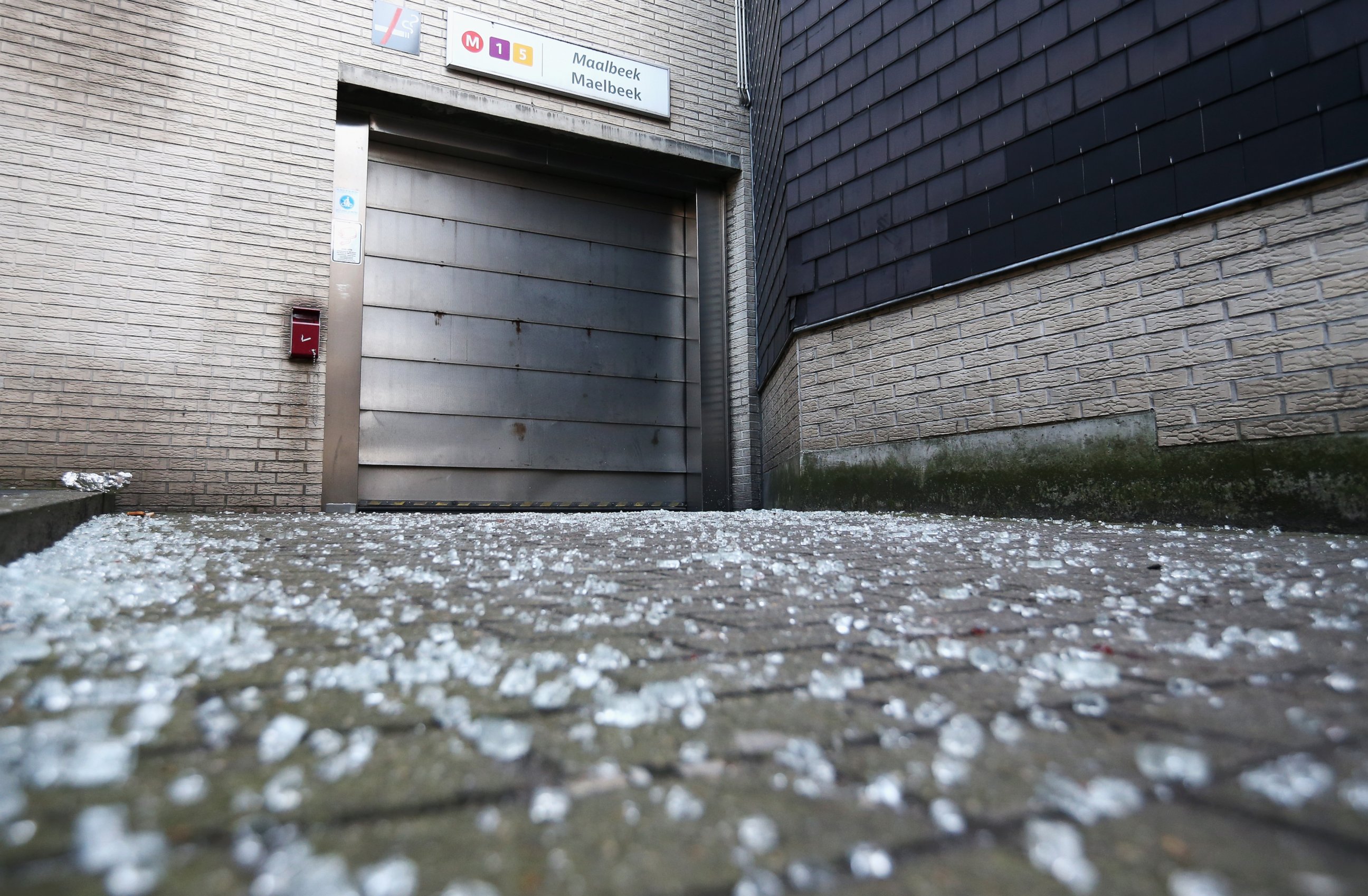 PHOTO: Broken glass is seen outside an entrance to Maelbeek metro station following the attacks on March 22, 2016 in Brussels, Belgium. 