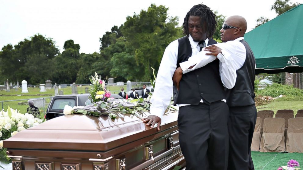 PHOTO: Brandon Risher, left, is comforted beside the casket of his grandmother, Ethel Lance, 70, one of nine victims of a mass shooting at the Emanuel AME Church, June 25, 2015 in North Charleston, South Carolina. 