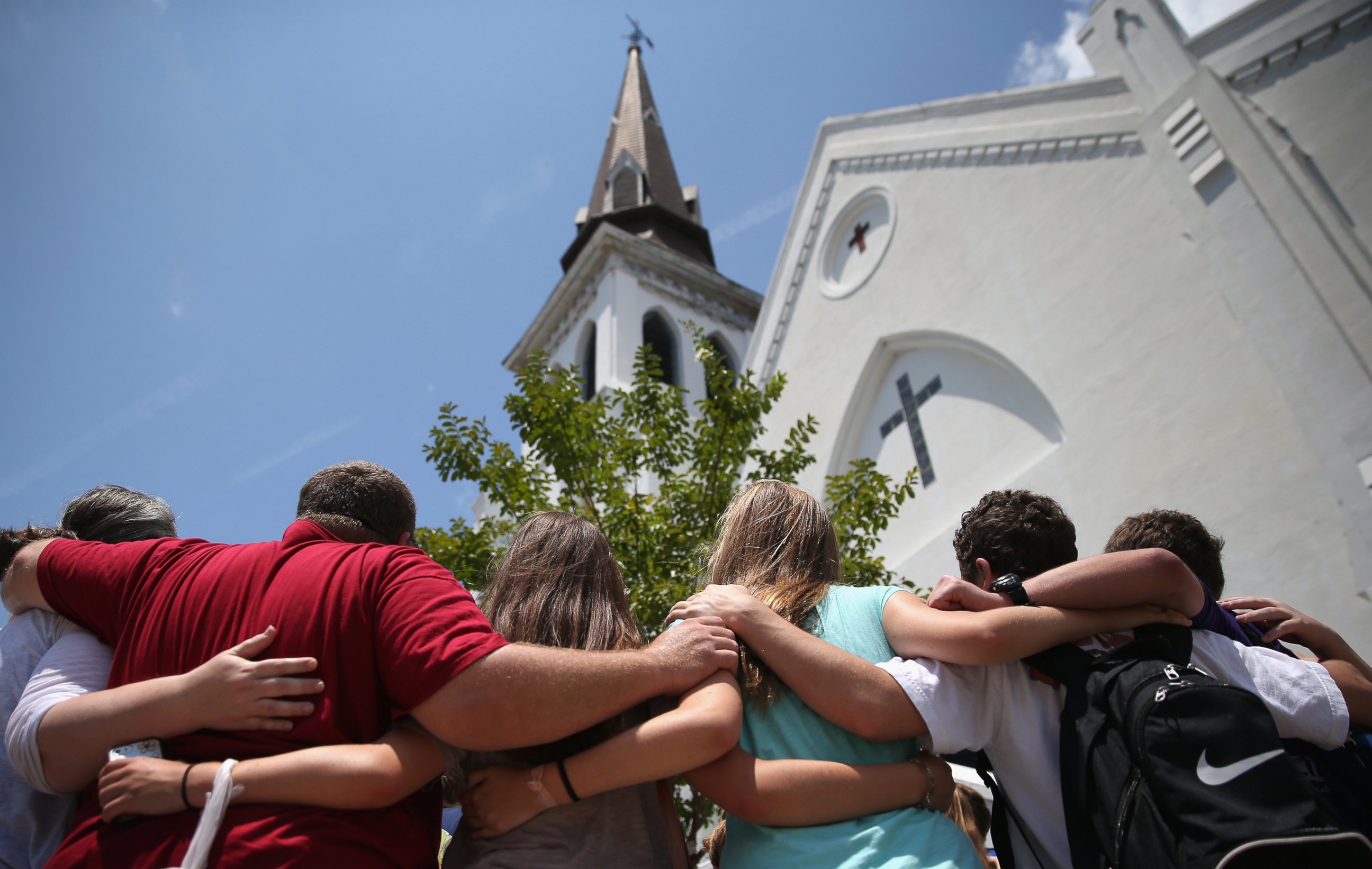PHOTO: A church youth group from Dothan, Alabama prays in front of the Emanuel AME Church on the one-month anniversary of the mass shooting, July 17, 2015, in Charleston, South Carolina.