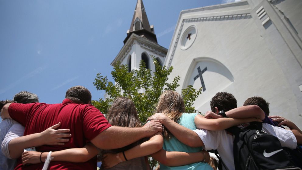 PHOTO: A church youth group from Dothan, Alabama prays in front of the Emanuel AME Church on the one-month anniversary of the mass shooting, July 17, 2015, in Charleston, South Carolina.