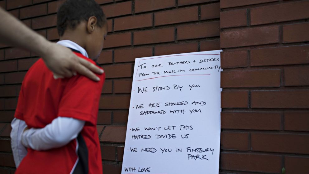 PHOTO: A boy reads a sign outside Finsbury Park Mosque on June 19, 2017 in London. Worshippers were struck by a hired van as they were leaving the mosque following Ramadan prayers