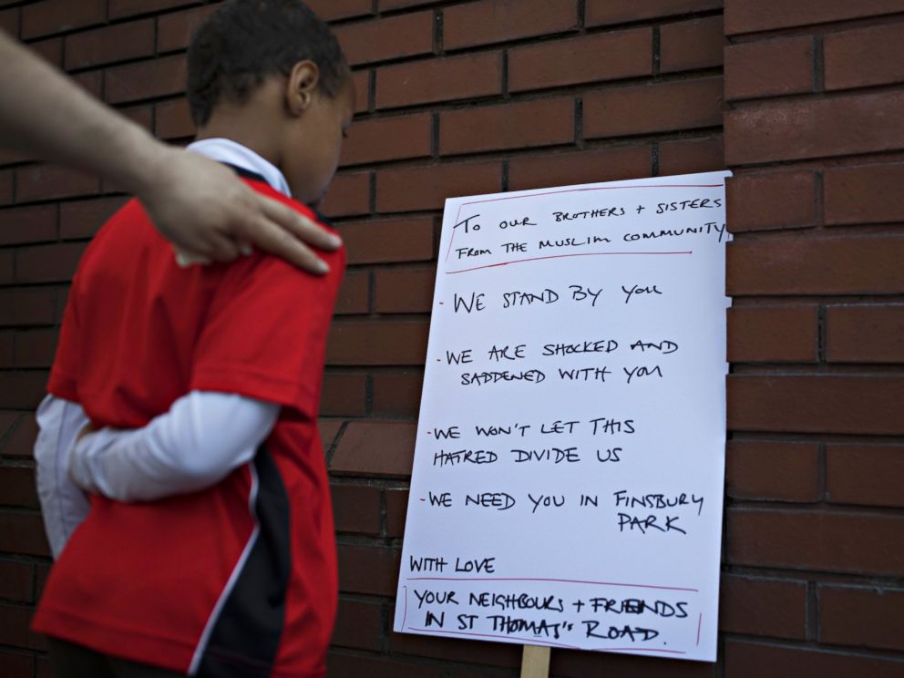 PHOTO: A boy reads a sign outside Finsbury Park Mosque on June 19, 2017 in London. Worshippers were struck by a hired van as they were leaving the mosque following Ramadan prayers