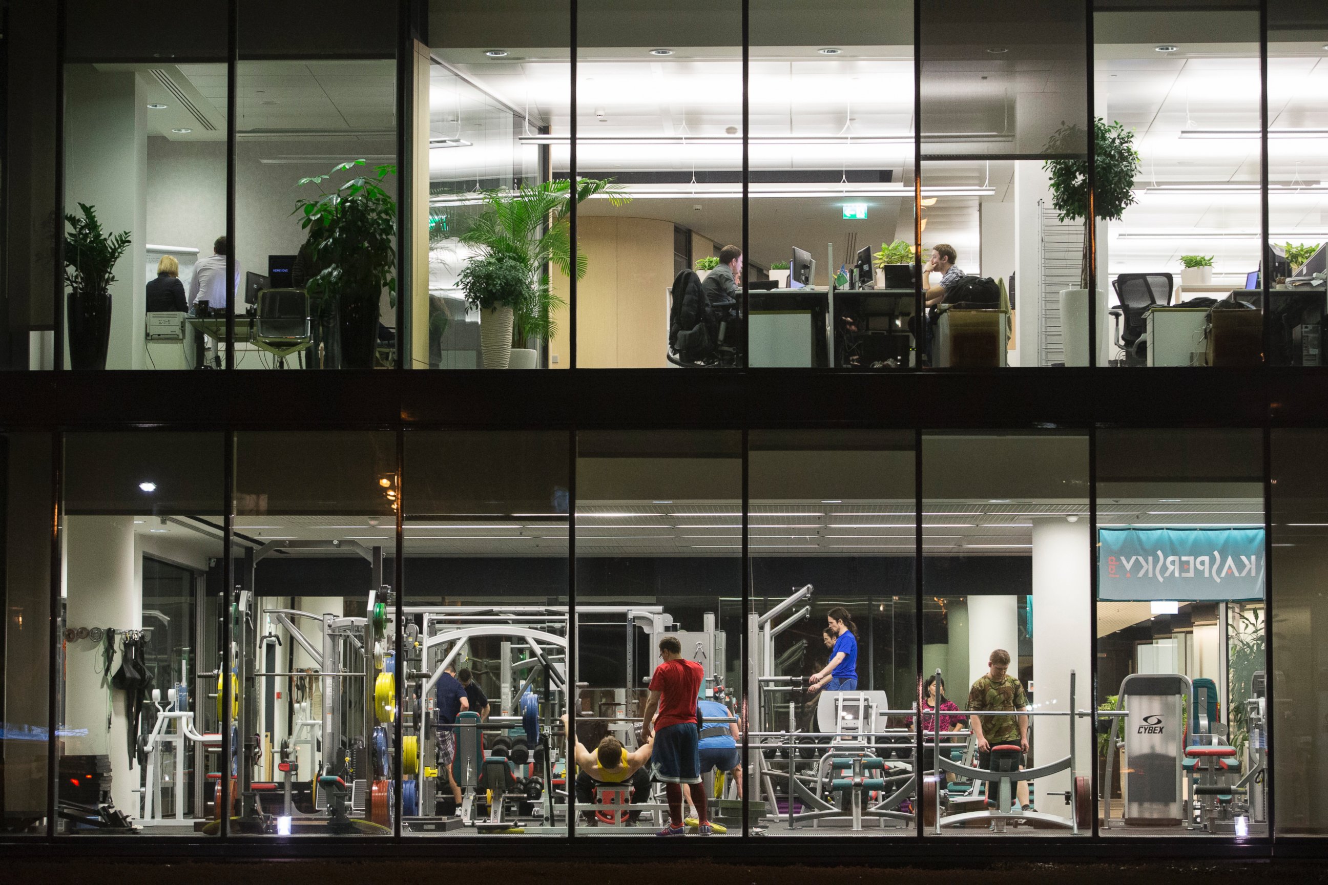 PHOTO: Employees train in a gym and work at their office desks at the headquarters of Kaspersky Lab, a cyber-security firm, in Moscow, on Dec. 9, 2014.