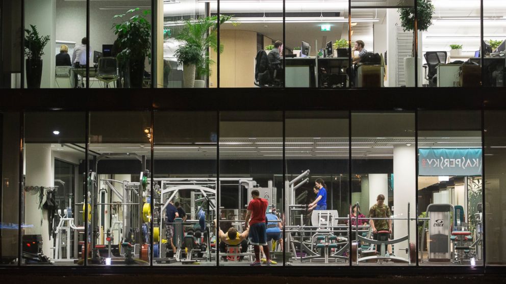 PHOTO: Employees train in a gym and work at their office desks at the headquarters of Kaspersky Lab, a cyber-security firm, in Moscow, on Dec. 9, 2014.