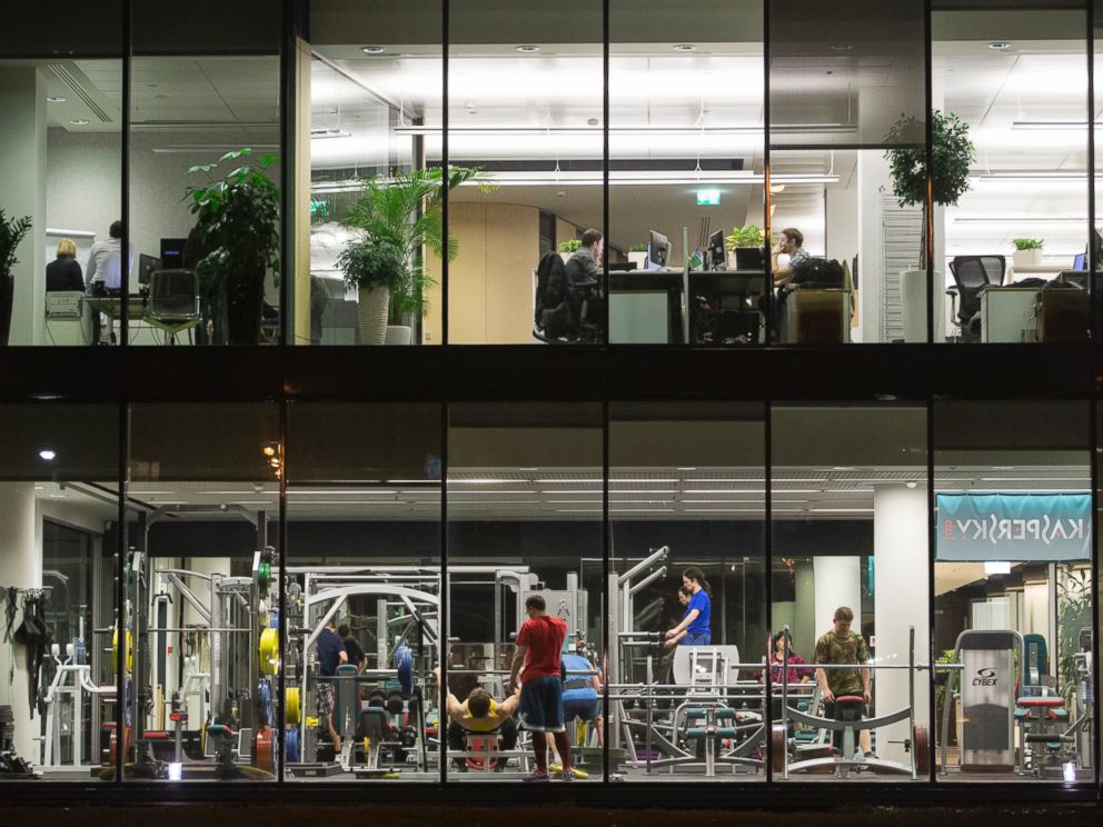 PHOTO: Employees train in a gym and work at their office desks at the headquarters of Kaspersky Lab, a cyber-security firm, in Moscow, on Dec. 9, 2014.
