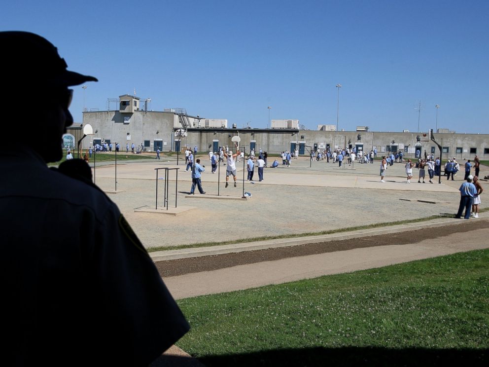 PHOTO: A California Department of Corrections officer looks on as inmates at the Mule Creek State Prison exercise in the yard August 28, 2007 in Ione, California