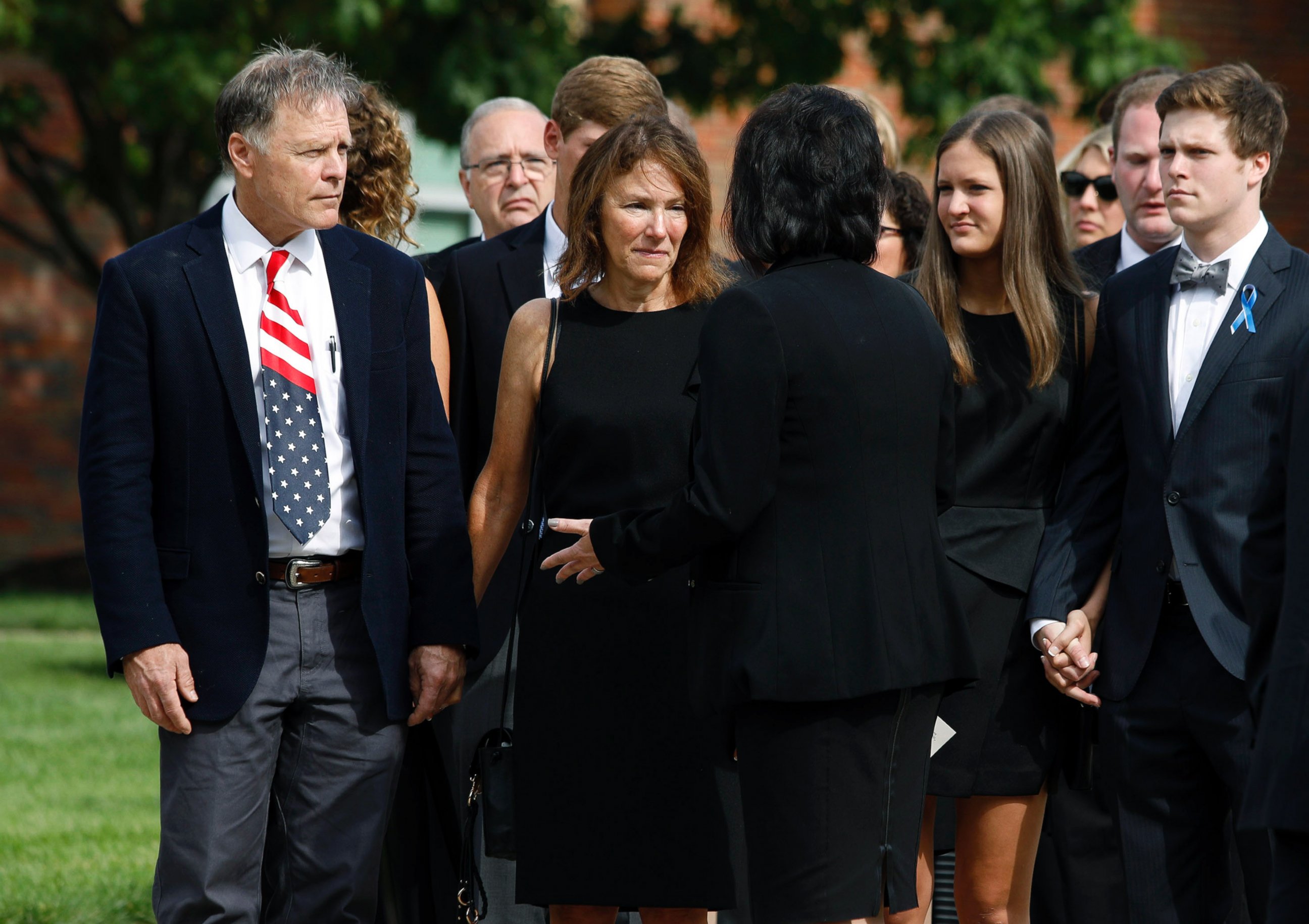 PHOTO: Fred and Cindy Warmbier, left speak with a woman after watching their son Otto Warmbier's casket carried out from his funeral at Wyoming High School on June 22, 2017 in Wyoming. 