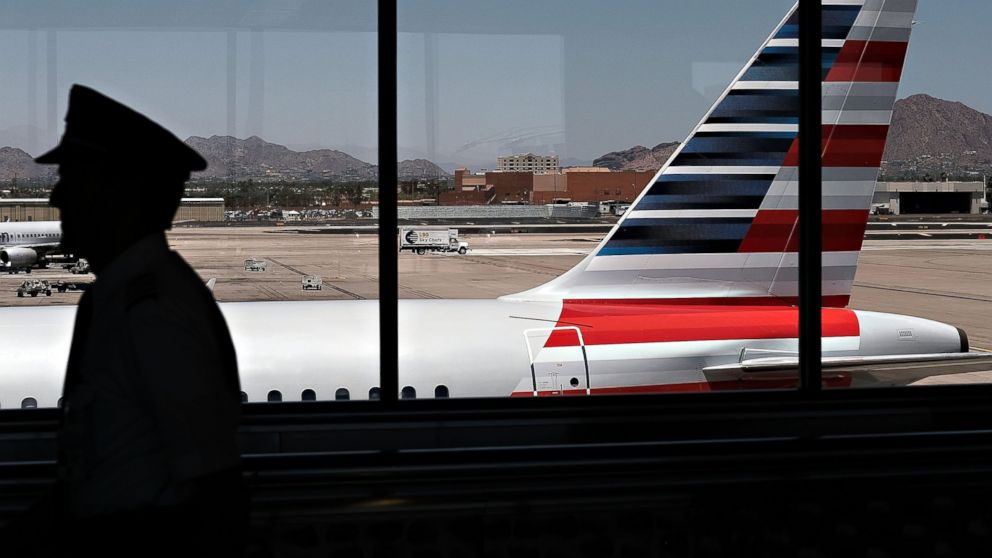 A pilot walks through the airport, May 24, 2016, in Phoenix.