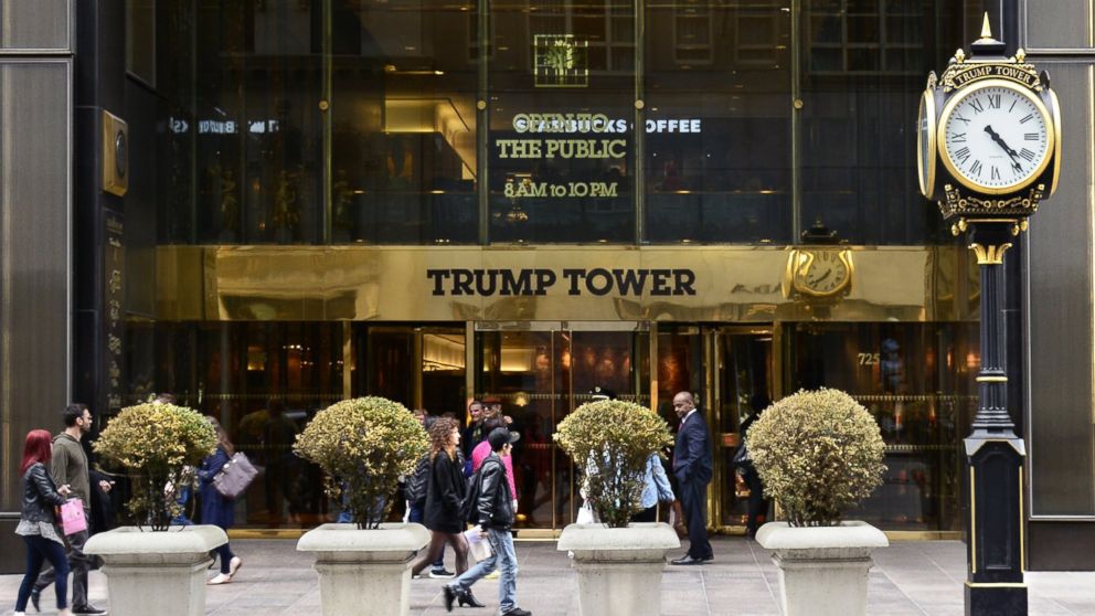New York City shoppers and visitors walk past the entrance to Trump Tower on Fifth Avenue, a mixed use skyscraper owned by Donald Trump, April 26, 2015.