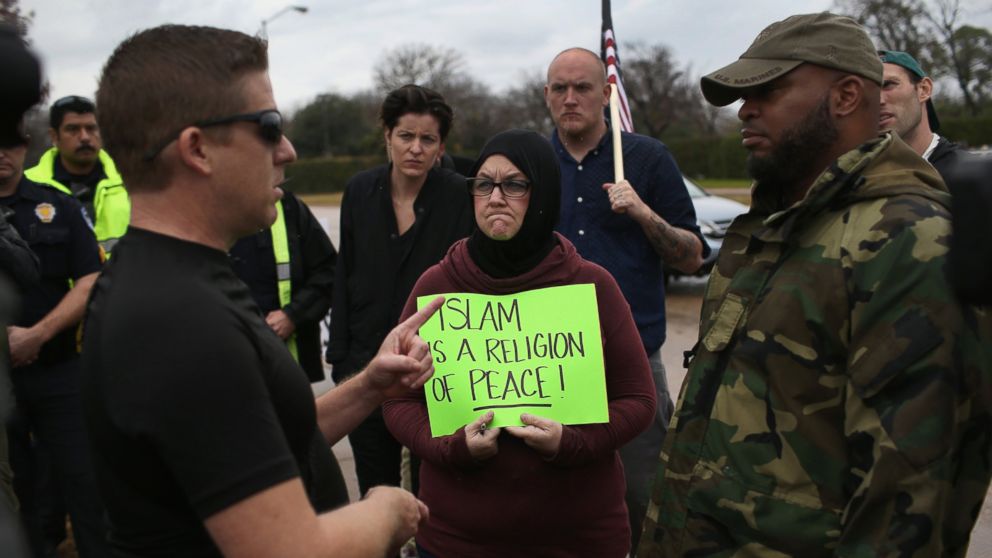 PHOTO: Protest leader David Wright, from the so-called Bureau of American-Islamic Relations (BAIR), speaks with a counter-demonstrator in front of the Islamic Association of North Texas at the Dallas Central Mosque, Dec. 12, 2015, in Richardson, Texas. 