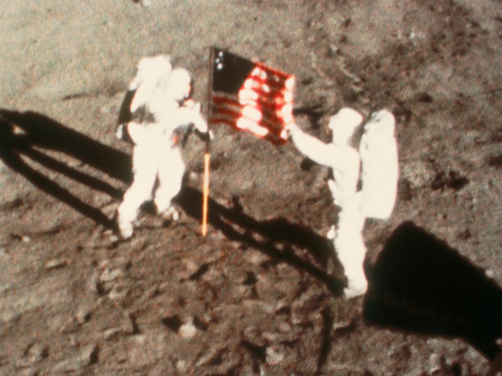 PHOTO: Astronauts Neil Armstrong and Edwin Aldrin climb down from Apollo 11 to become the first humans to set foot on another planetary body, 20 July 1969.