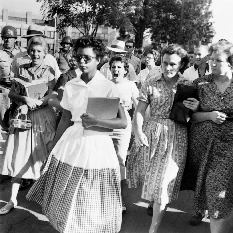 PHOTO: Elizabeth Eckford ignores the hostile screams and stares of fellow students on her first day of school. 